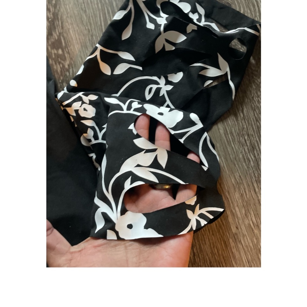 WORN ONCE! SUPER CUTE CAPRI PANTS WITH FLORAL HEM AND HOLE ACCENTS! - Picture 7 of 9